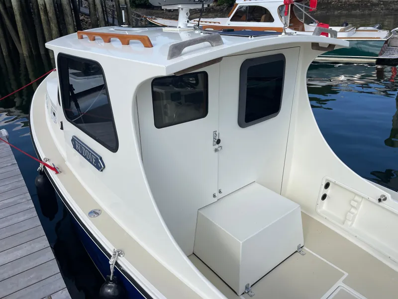 Slide: The Image of 2003 Atlas Boat Works Pompano 21 docked, showcasing cabin and deck details. - 26
