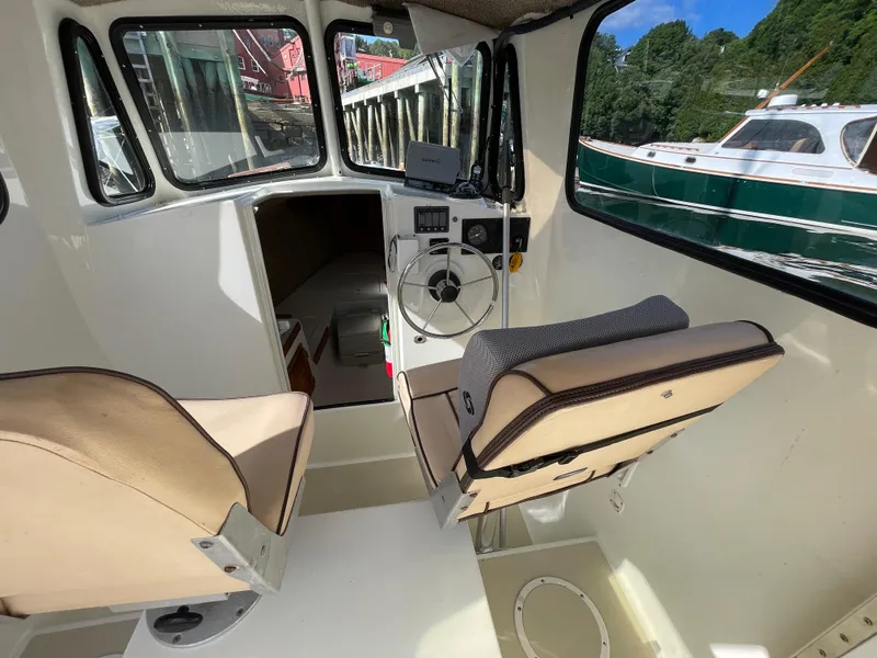 Slide: The Image of Interior of 2003 Atlas Boat Works Pompano 21, featuring helm and seating. - 30