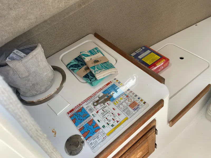 Slide: The Image of Interior of 2003 Atlas Boat Works Pompano 21 with navigation chart and supplies. - 34