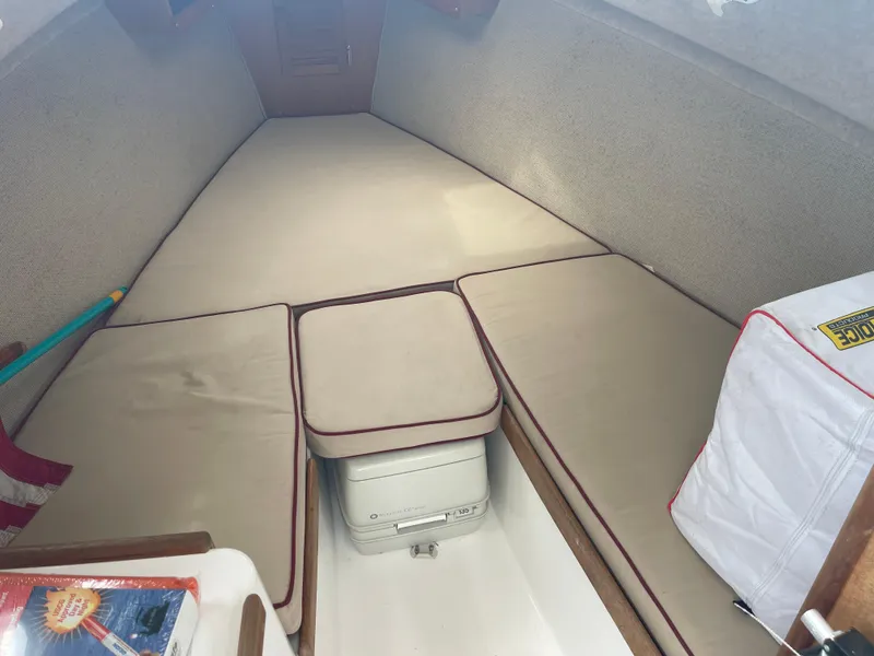 Slide: The Image of 2003 Atlas Boat Works Pompano 21 cabin interior with beige cushions and storage. - 36