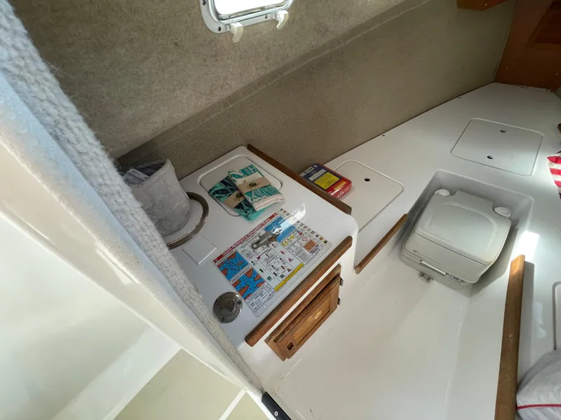 Slide: The Image of Interior of 2003 Atlas Boat Works Pompano 21, featuring compact cabin amenities. - 37