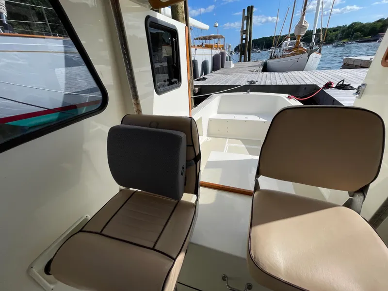 Slide: The Image of Interior view of 2003 Atlas Boat Works Pompano 21, featuring seating and dockside location. - 42