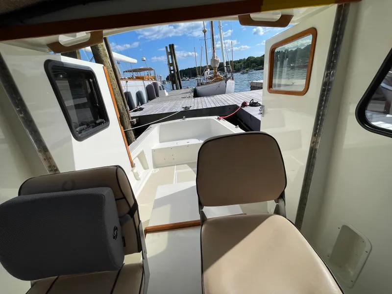 Slide: The Image of Interior view of 2003 Atlas Boat Works Pompano 21, docked with scenic marina backdrop. - 43