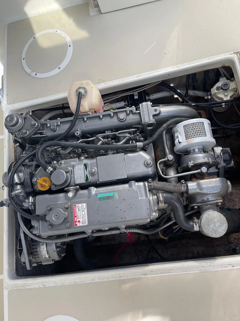 Slide: The Image of Engine compartment of a 2003 Atlas Boat Works Pompano 21, showcasing detailed machinery. - 48