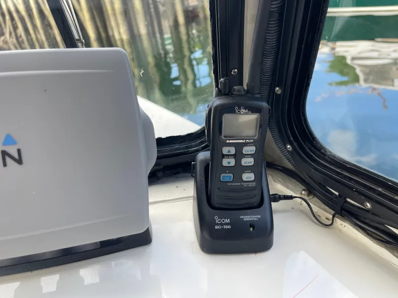 Slide: The Image of Icom VHF marine radio on 2003 Atlas Boat Works Pompano 21 dashboard. - 52