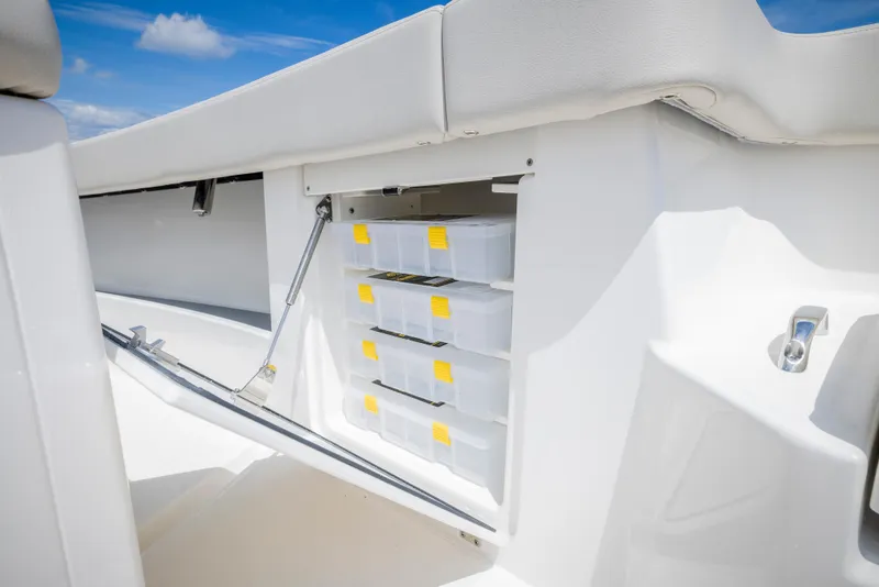 Slide: The Image of Storage compartment on 2025 Solace 30 HCS boat, featuring organized tackle boxes. - 10