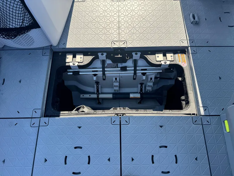 Slide: The Image of 2023 Sea-Doo Switch Cruise 18 storage compartment with open hatch, showcasing interior details. - 21