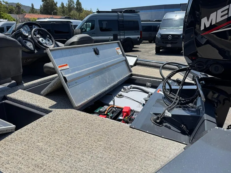 Slide: The Image of 2022 Tracker Pro Team 175 TF boat interior with open storage compartment and visible engine components. - 11
