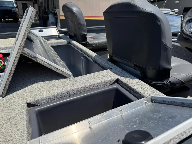 Slide: The Image of 2022 Tracker Pro Team 175 TF boat interior with open storage compartments and seating. - 15