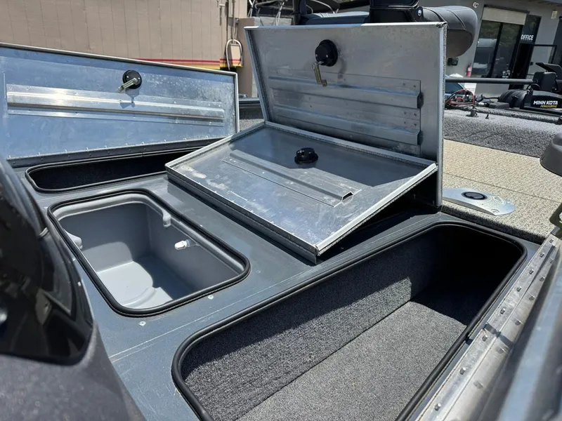 Slide: The Image of 2022 Tracker Pro Team 175 TF boat storage compartments open, showcasing interior space. - 16