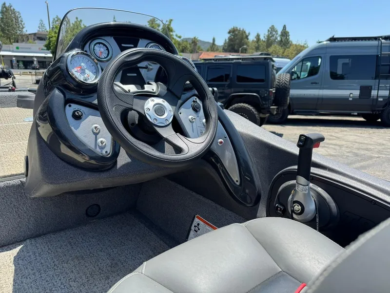 Slide: The Image of 2022 Tracker Pro Team 175 TF boat dashboard with steering wheel and controls. - 21