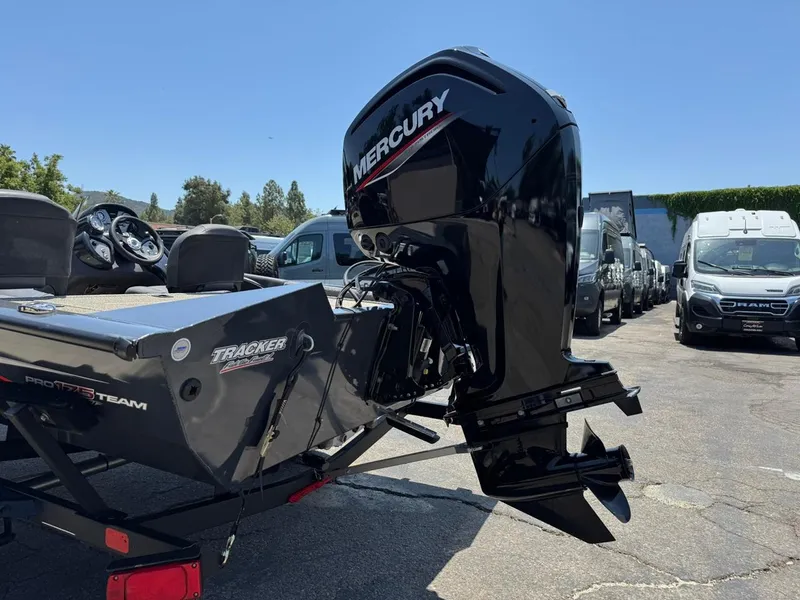 Slide: The Image of 2022 Tracker Pro Team 175 TF boat with Mercury outboard motor in a parking lot. - 26