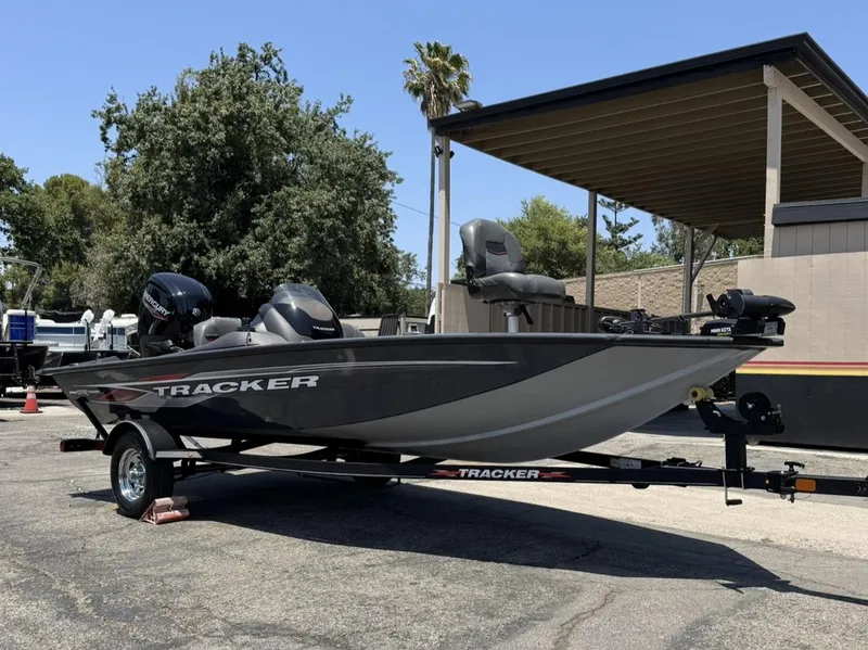 Slide: The Image of 2022 Tracker Pro Team 175 TF fishing boat on trailer, parked outdoors. - 3