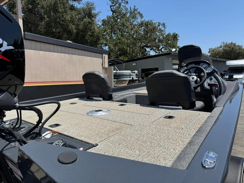 Slide: The Image of 2022 Tracker Pro Team 175 TF boat with dual seats and control panel, parked outdoors. - 7
