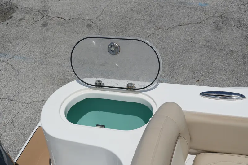 Slide: The Image of Open hatch on 2022 NauticStar 2602 boat, revealing storage compartment. - 11