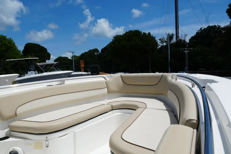Slide: The Image of 2022 NauticStar 2602 boat with beige seating under a clear blue sky. - 15