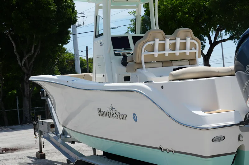 Slide: The Image of 2022 NauticStar 2602 boat on trailer, featuring sleek design and comfortable seating. - 17