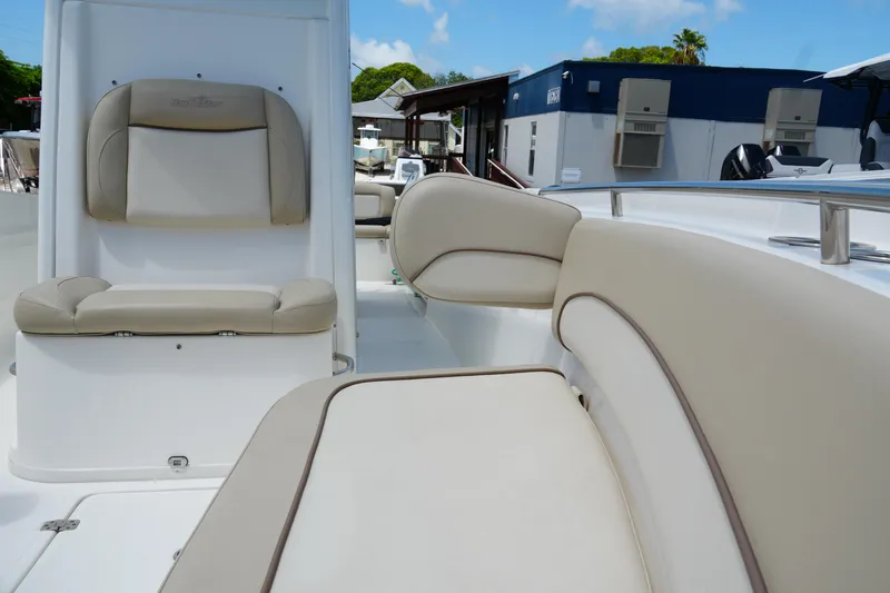 Slide: The Image of 2022 NauticStar 2602 boat interior with beige seating and modern design. - 18