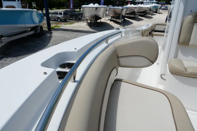 Slide: The Image of 2022 NauticStar 2602 boat interior with beige seating and stainless steel railings. - 19