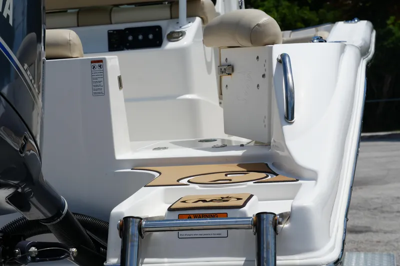 Slide: The Image of 2022 NauticStar 2602 boat stern with ladder and seating area. - 20