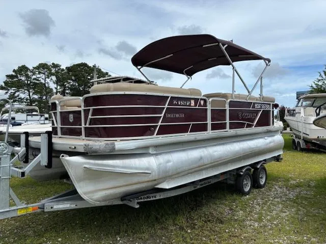 The Image of 2021 Sweetwater 2186 pontoon boat on trailer, parked outdoors. - 1
