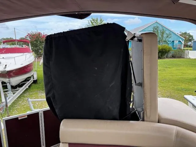 Slide: The Image of Interior of a 2021 Sweetwater 2186 boat with covered equipment and outdoor view. - 17