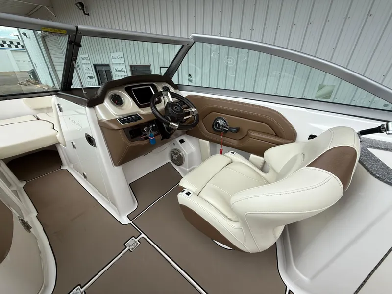Slide: The Image of Interior of 2018 Chaparral 244 Sunesta Surf boat with steering wheel and seating. - 12