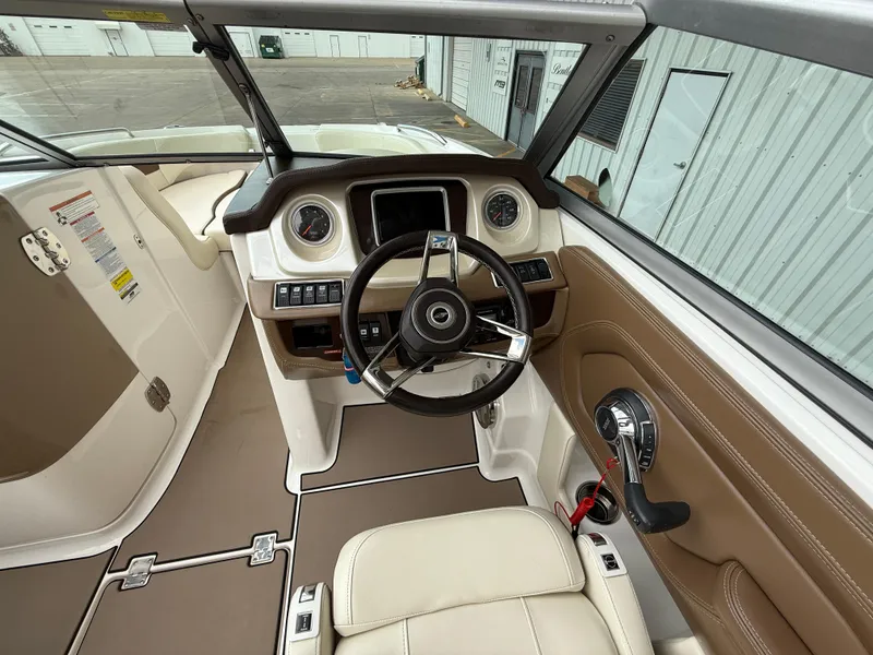 Slide: The Image of 2018 Chaparral 244 Sunesta Surf boat interior with steering wheel and dashboard controls. - 13