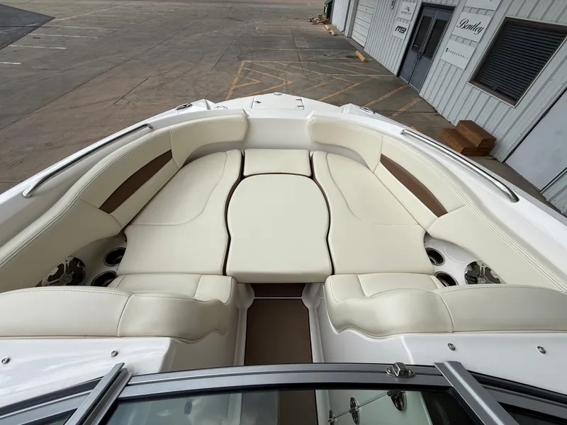 Slide: The Image of 2018 Chaparral 244 Sunesta Surf boat interior with cream seating and cup holders. - 14