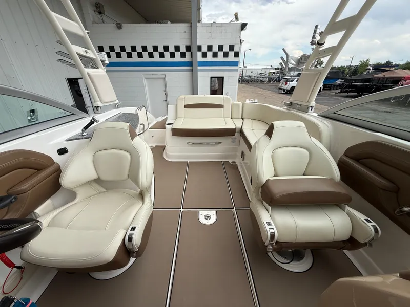 Slide: The Image of 2018 Chaparral 244 Sunesta Surf boat interior with beige and brown seating. - 15