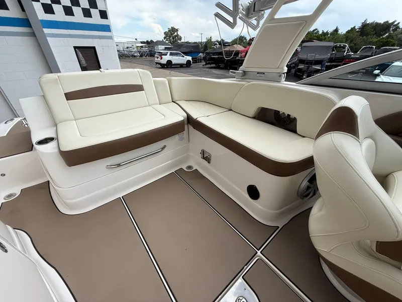 Slide: The Image of 2018 Chaparral 244 Sunesta Surf boat interior with beige and brown seating. - 16