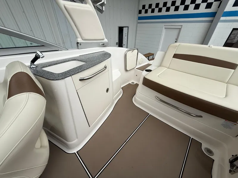 Slide: The Image of 2018 Chaparral 244 Sunesta Surf boat interior with seating and kitchenette area. - 17