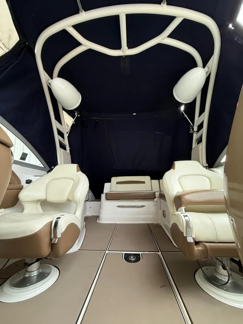 Slide: The Image of 2018 Chaparral 244 Sunesta Surf boat interior with plush seating and canopy. - 20