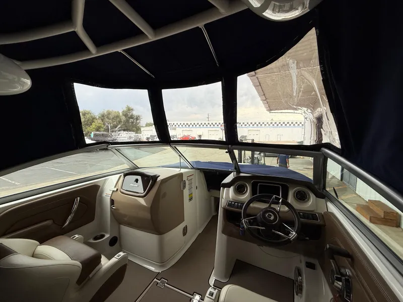 Slide: The Image of Interior view of 2018 Chaparral 244 Sunesta Surf boat cockpit with steering wheel and seating. - 22