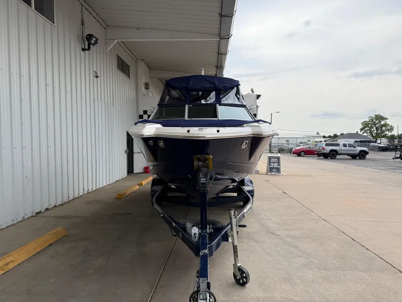 Slide: The Image of 2018 Chaparral 244 Sunesta Surf boat on trailer in a covered area. - 26