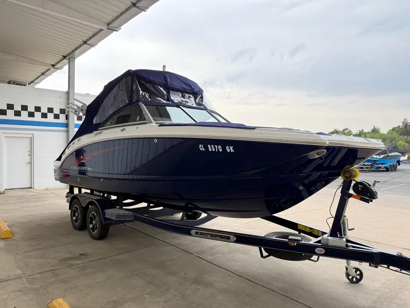 Slide: The Image of 2018 Chaparral 244 Sunesta Surf boat on trailer in covered area. - 27