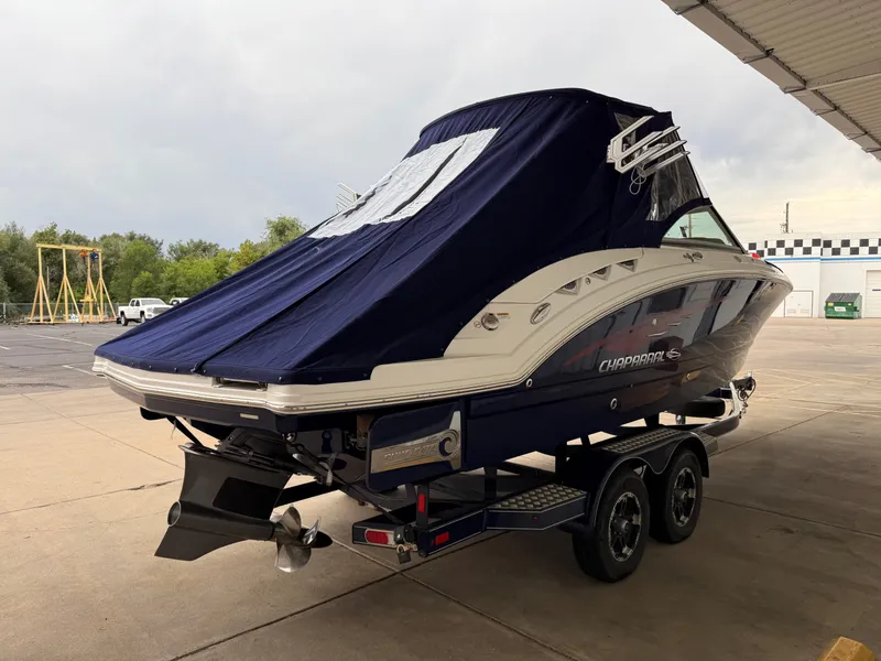 Slide: The Image of 2018 Chaparral 244 Sunesta Surf boat on trailer, covered, parked outdoors. - 29
