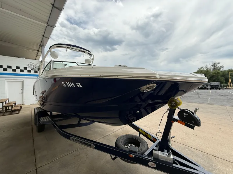 Slide: The Image of 2018 Chaparral 244 Sunesta Surf boat on trailer under cloudy sky. - 3