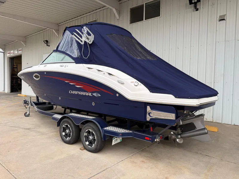 Slide: The Image of 2018 Chaparral 244 Sunesta Surf boat on trailer, covered, parked in a garage. - 31