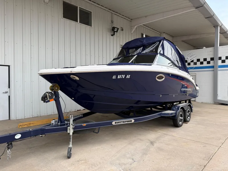 Slide: The Image of 2018 Chaparral 244 Sunesta Surf boat on trailer, parked under a canopy. - 32