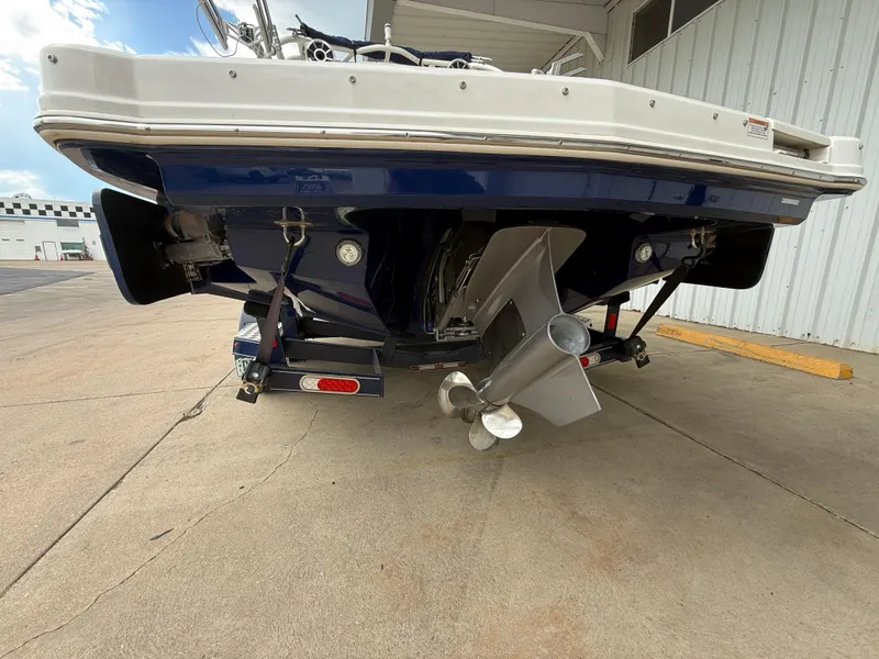 Slide: The Image of 2018 Chaparral 244 Sunesta Surf boat rear view, showcasing propeller and hull design. - 7