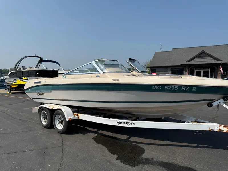 The Image of 1995 Seaswirl 201 boat on trailer, parked outdoors near a building. - 0