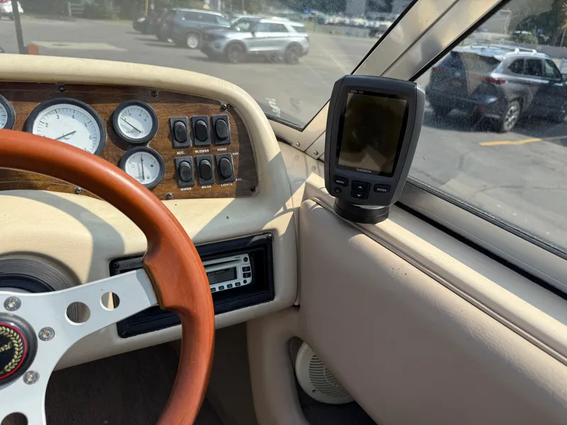 Slide: The Image of 1995 Seaswirl 201 boat dashboard with steering wheel, gauges, and Garmin device. - 12