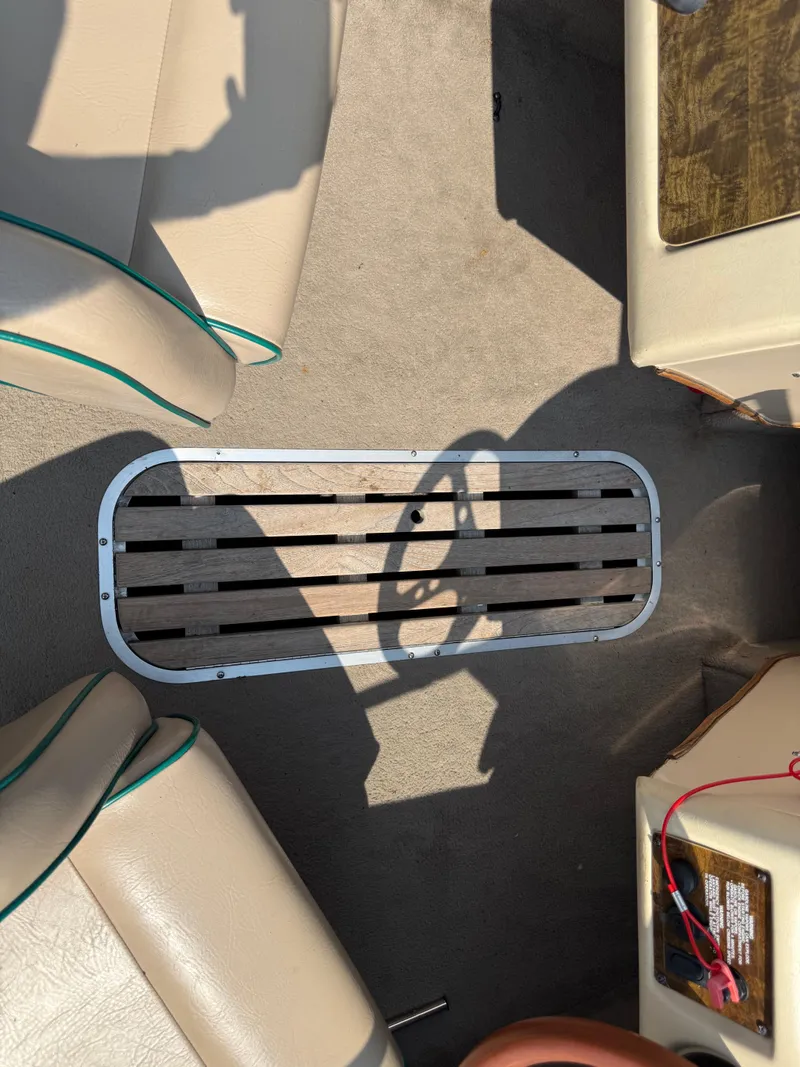 Slide: The Image of 1995 Seaswirl 201 boat interior with beige seats and wooden floor panel. - 15