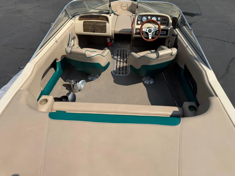 Slide: The Image of 1995 Seaswirl 201 boat interior with beige and teal seating, steering wheel, and dashboard. - 18