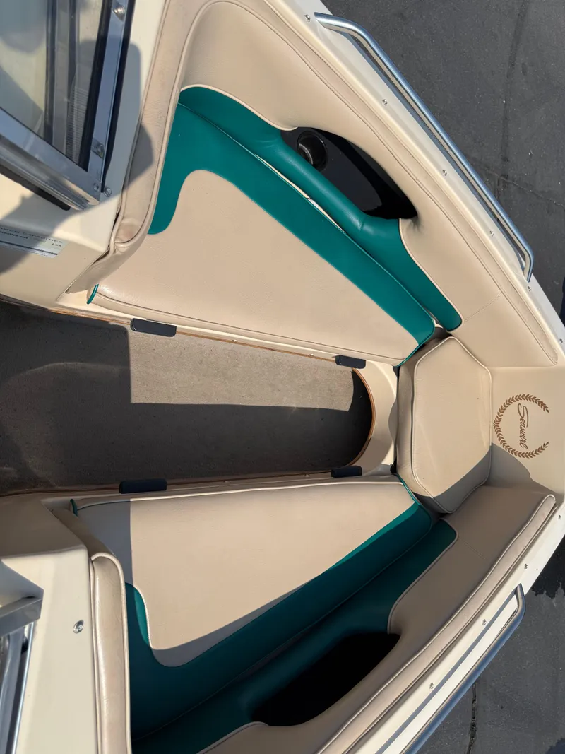 Slide: The Image of 1995 Seaswirl 201 boat interior with beige and teal seating, open bow design. - 6