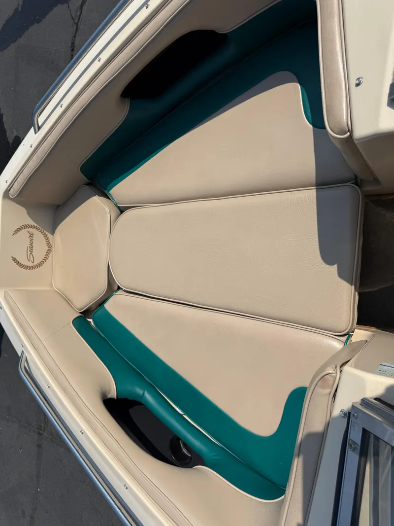 Slide: The Image of 1995 Seaswirl 201 boat interior with beige and teal seating, showcasing elegant design. - 7