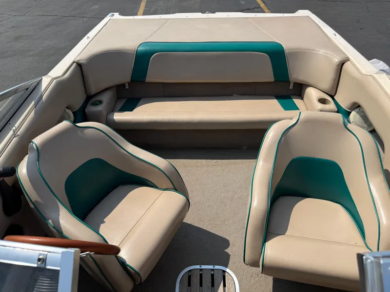 Slide: The Image of 1995 Seaswirl 201 boat interior with beige and teal seating, showing helm and passenger seats. - 8