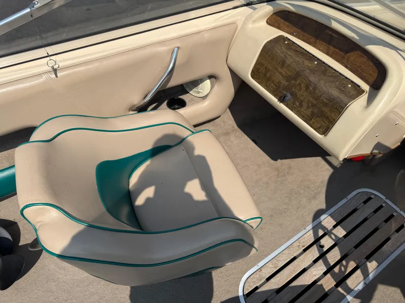 Slide: The Image of Interior of a 1995 Seaswirl 201 boat with beige seating and wood accents. - 9