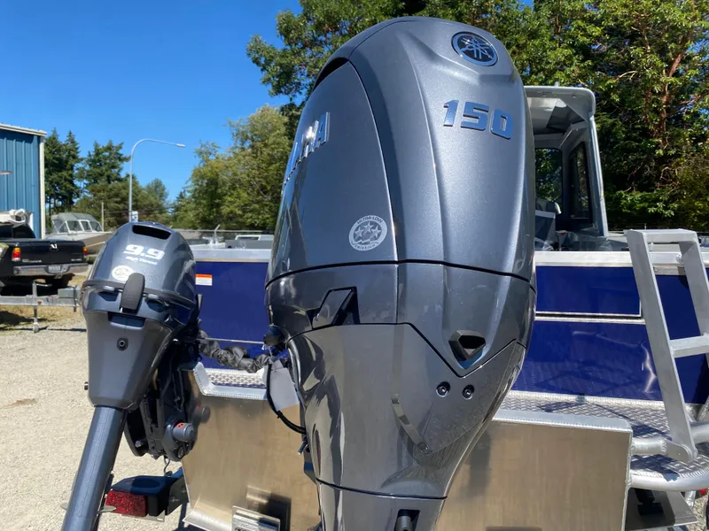 Slide: The Image of 2025 Hewescraft 190 Sea Runner HT with Yamaha outboard motors, parked outdoors. - 12